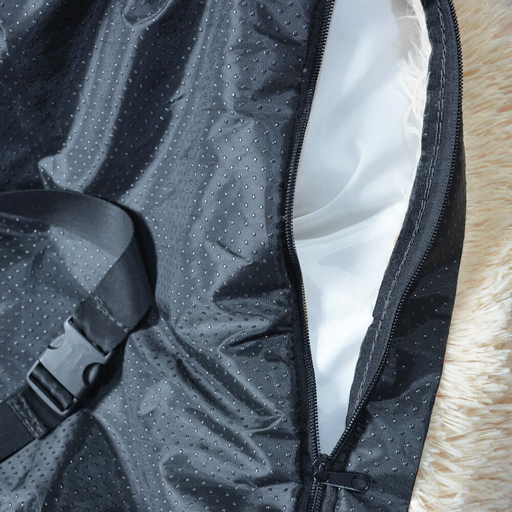 Close-up of the interior of a washable dog car seat bed, featuring a durable black material and zipper detail.