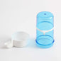 Automatic bird water dispenser in blue and white, featuring a large bottle and a measuring cup for easy feeding.