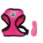 Fluffy white dog wearing a pink harness, enjoying the outdoors, promoting safety with a pet car seat belt leash.