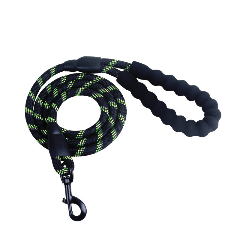 Person walking a dog on a reflective nylon dog leash in a forested area.