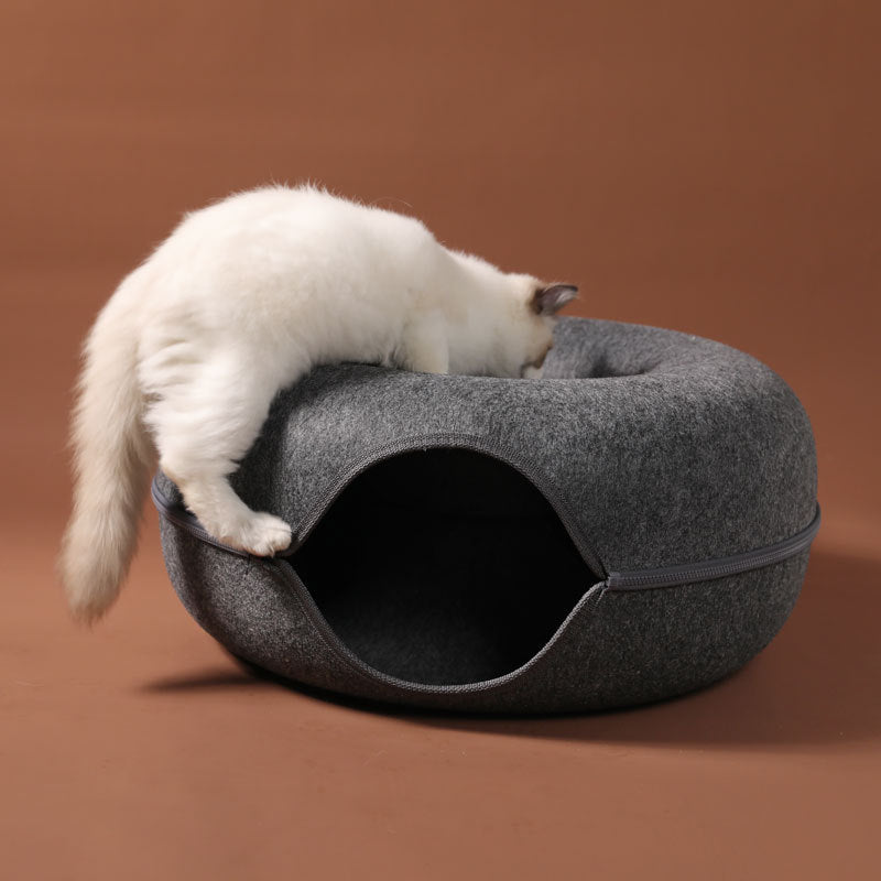 Cat exploring the 2-in-1 felt cat tunnel bed, a grey woolen felt interactive training toy.
