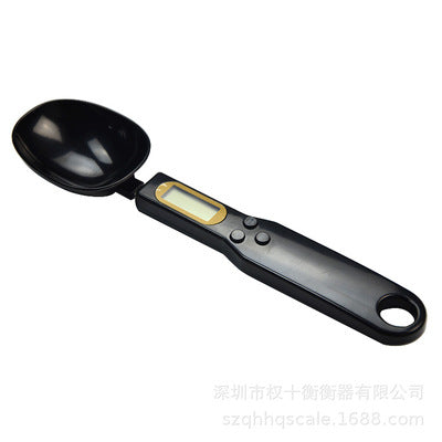 LCD digital kitchen scale with LCD display showing internal mechanism and removable battery cover.