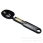 LCD digital kitchen scale with LCD display showing internal mechanism and removable battery cover.