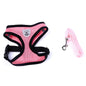 Fluffy white dog wearing a pink harness, enjoying the outdoors, promoting safety with a pet car seat belt leash.
