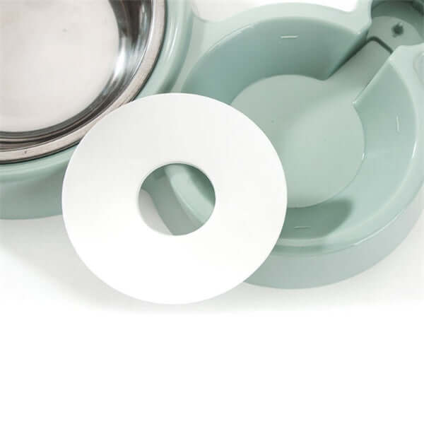 Interior view of an automatic dog water bowl showing stainless steel bowl and removable plastic insert.