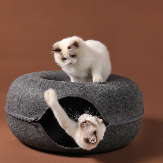 Two playful cats interacting with a 2-in-1 felt cat tunnel bed in stylish grey felt.