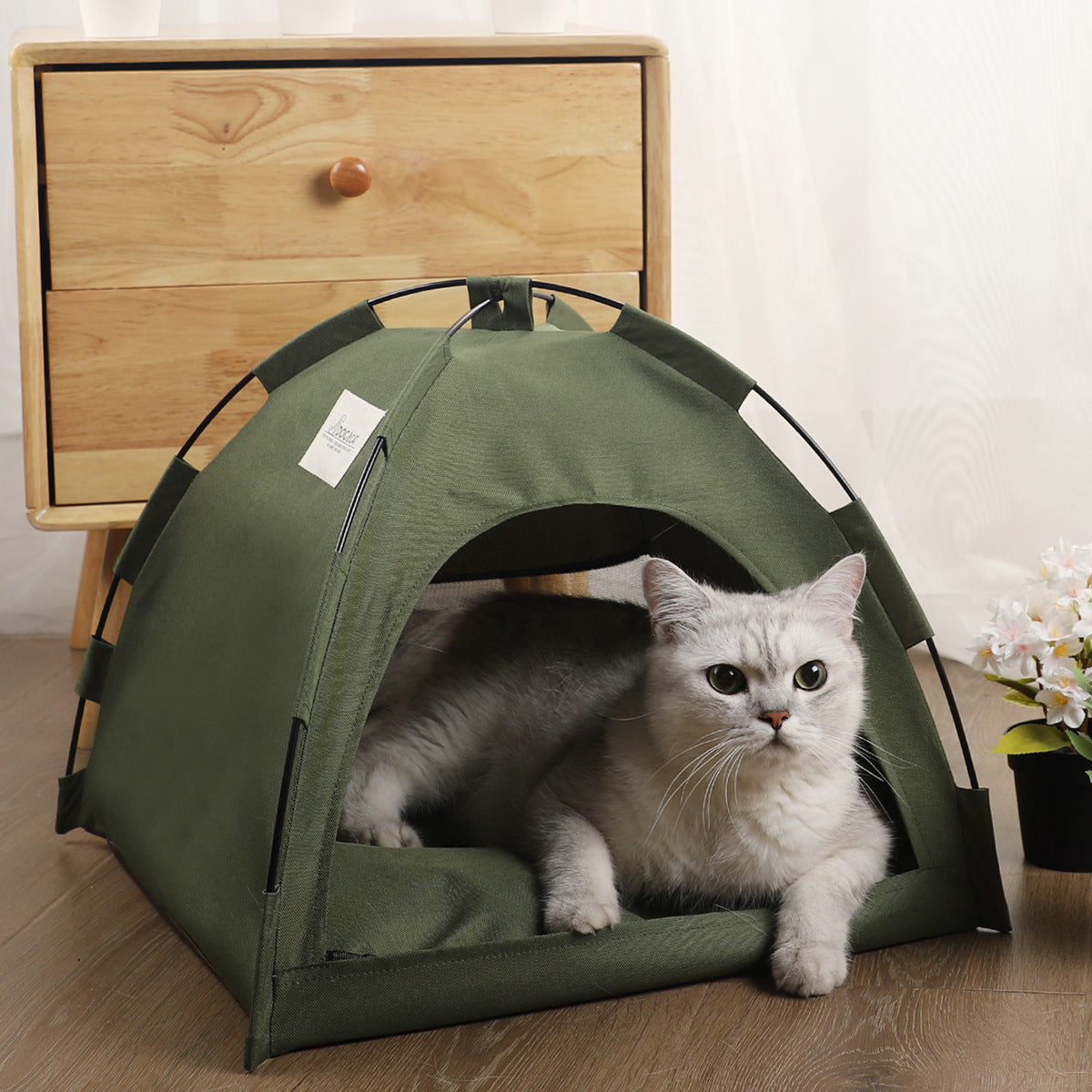Cat tent cooling mat with cozy green fabric, perfect for pets to relax indoors.