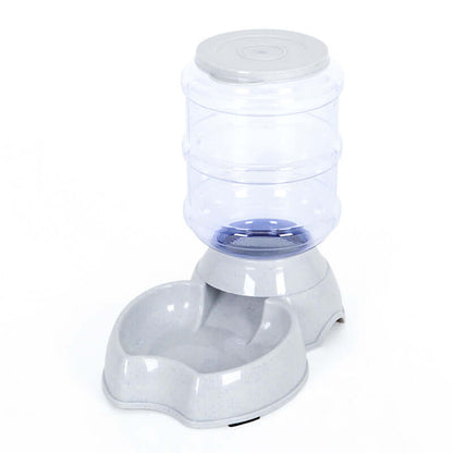 Automatic dog water bowl designed with a stainless steel bowl and plastic base, featuring a clear water reservoir.