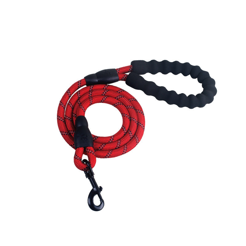 Person walking a dog on a reflective nylon dog leash in a forested area.
