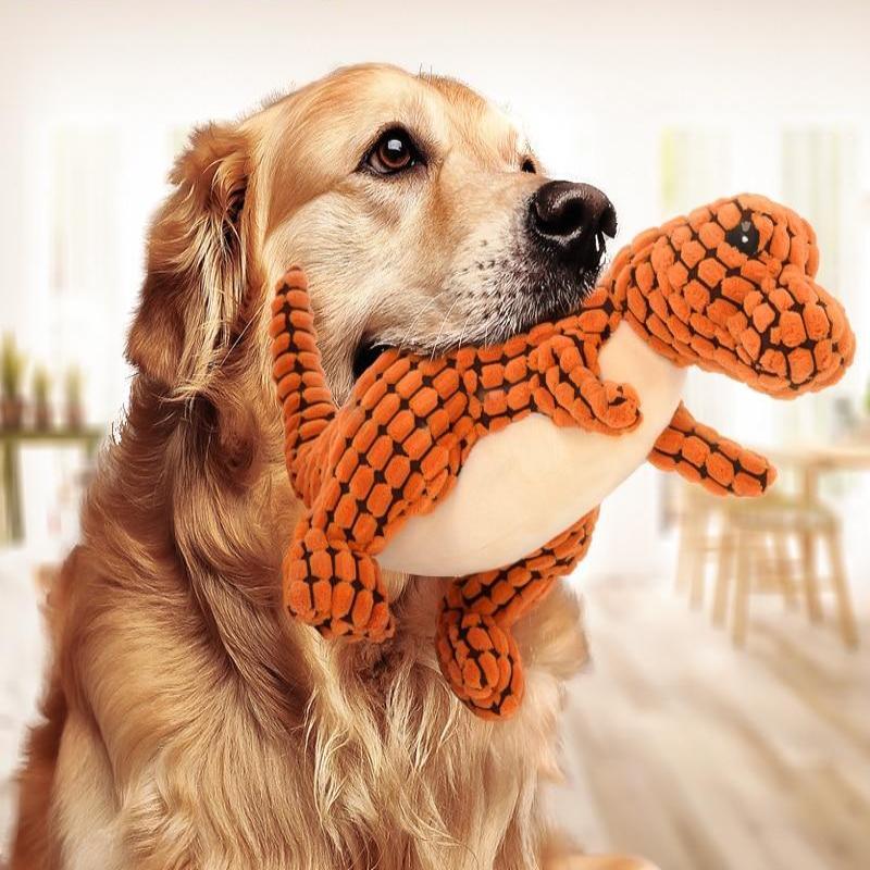Golden retriever playing with a dinosaur squeaky dog toy, perfect for large dog interactive playtime.