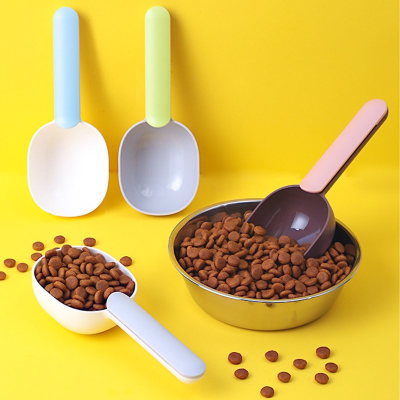 Colorful pet food scoop set with dog and cat food in bowls, featuring the essential pet food scoop for easy feeding.