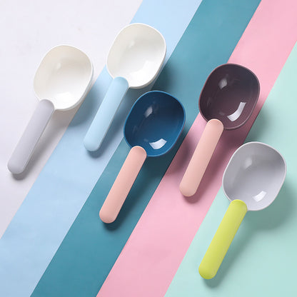 Colorful pet food scoops in various shades on a pastel background, ideal for measuring pet food accurately.