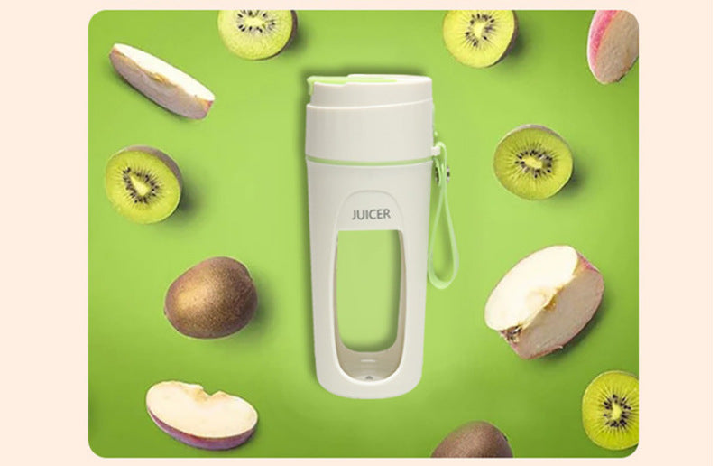 Portable USB blender cup surrounded by fresh fruits on a green background, showcasing its convenience for smoothies.