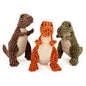 Close-up of a person squeezing a soft dinosaur squeaky dog toy in orange color.