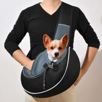 Person carrying a pet crossbody carrier bag with a dog inside, showcasing comfort and portability for pet transport.