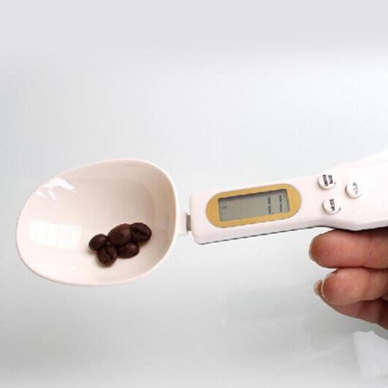 LCD digital kitchen scale with LCD display showing internal mechanism and removable battery cover.