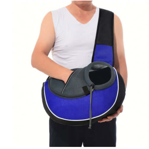 A person holding a pet crossbody carrier bag, featuring a breathable design and adjustable strap, ideal for dogs and cats.