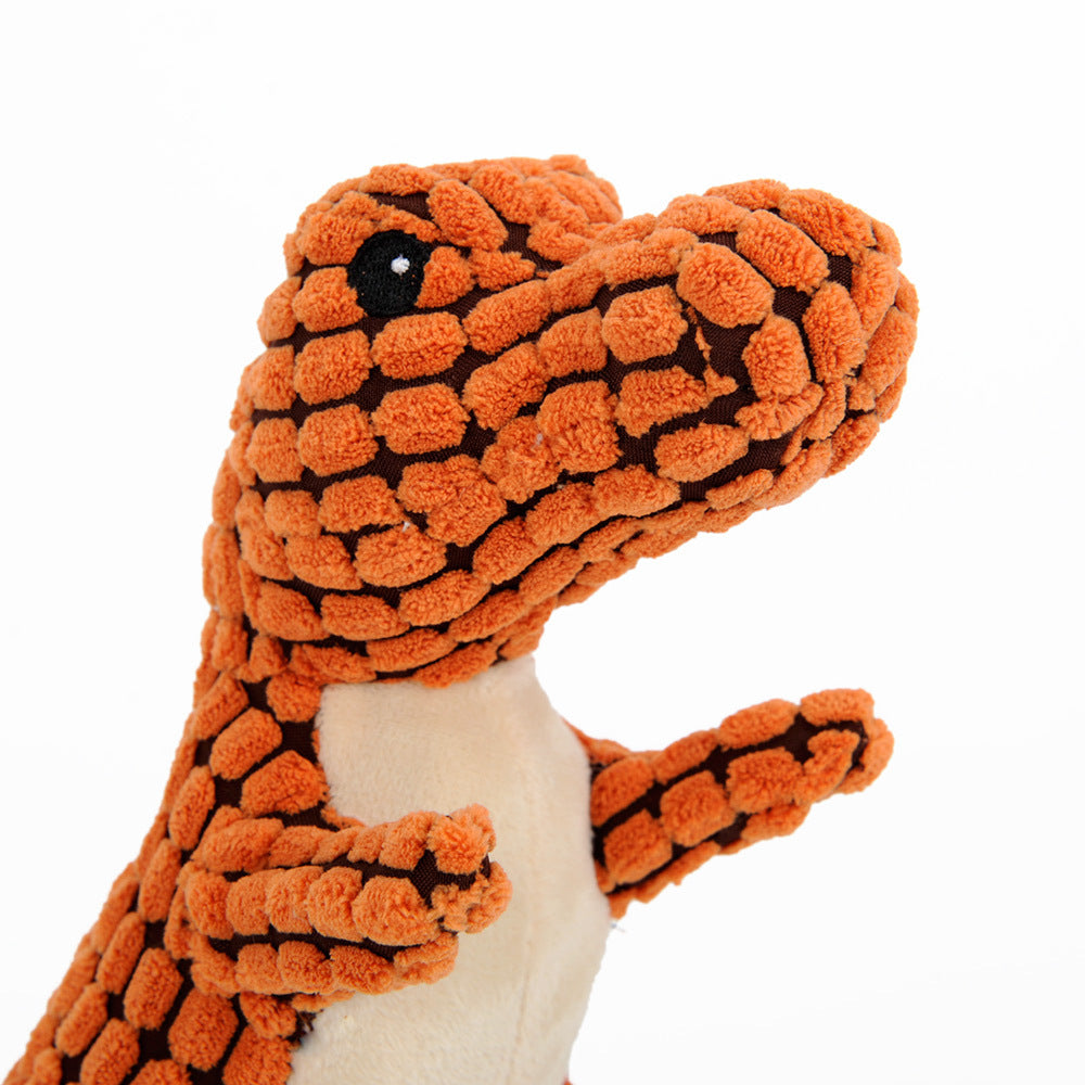 Close-up of a person squeezing a soft dinosaur squeaky dog toy in orange color.