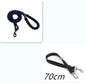 Person walking a dog on a reflective nylon dog leash in a forested area.