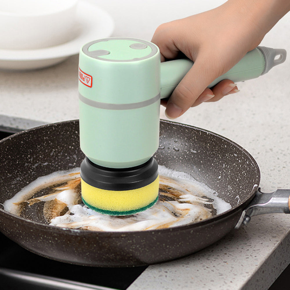 automatic electric cleaning brush scrubbing a greasy frying pan surface in kitchen.
